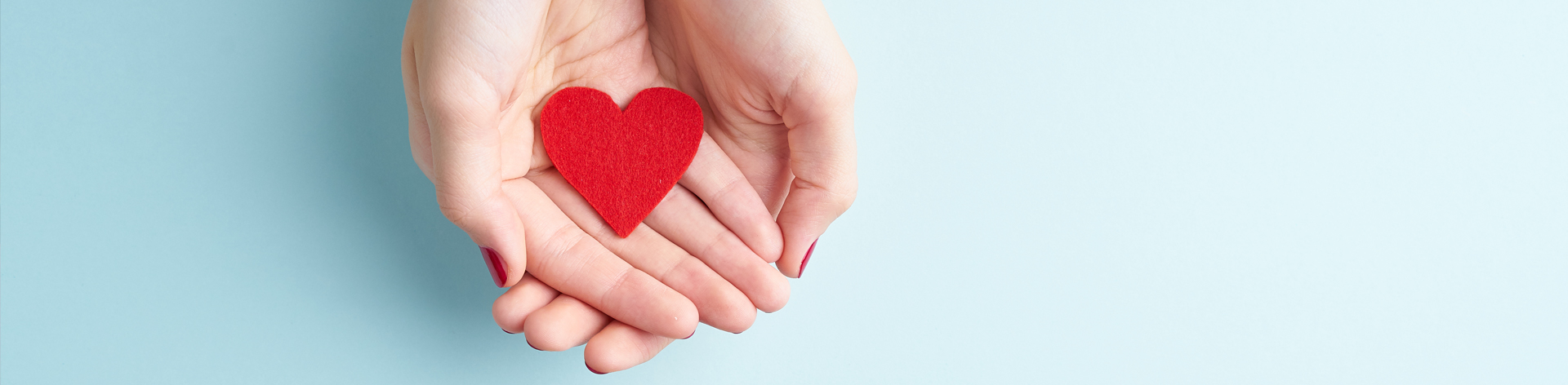 hands holding fabric heart.